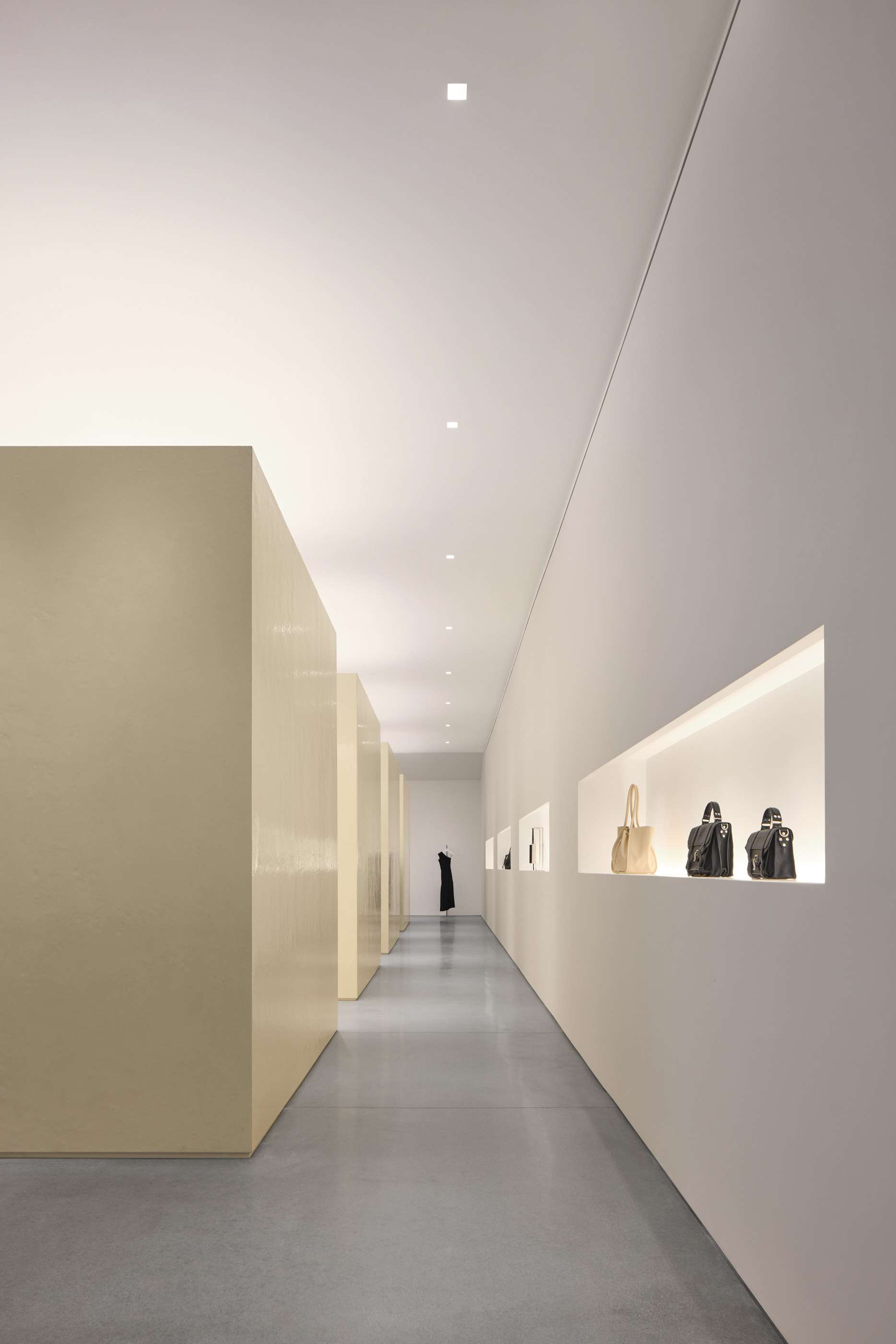 Hallway retail space showing coats and purses at Proenza