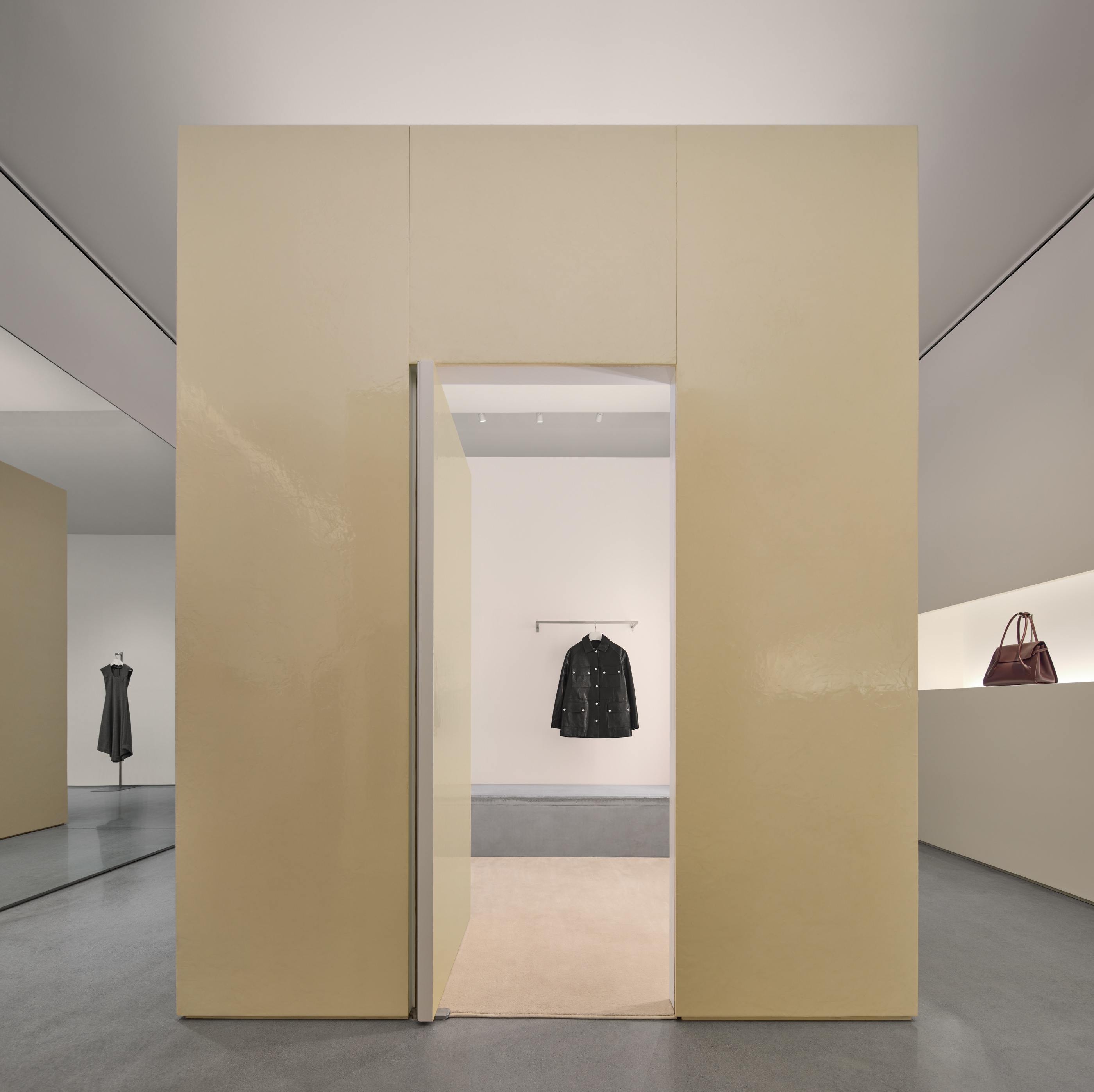 Interior retail space showing coats and purses at Proenza